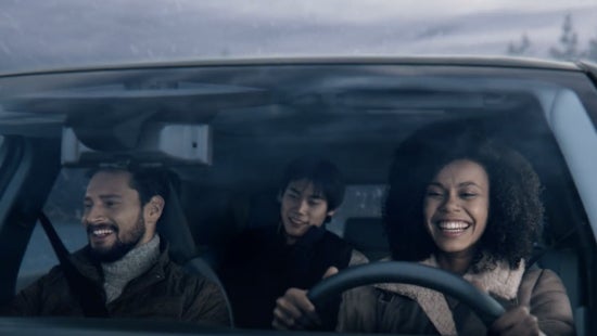 Three passengers riding in a vehicle and smiling | Vann York's High Point Nissan in High Point NC